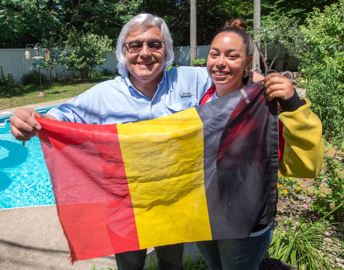 Belgian fan Robert Defays, and his daughter Audrey, show their colours at their home Monday, July 9, 2018 in Blainville, Quebec. Belgium will play France in the semi-finals at the World Cup of soccer.