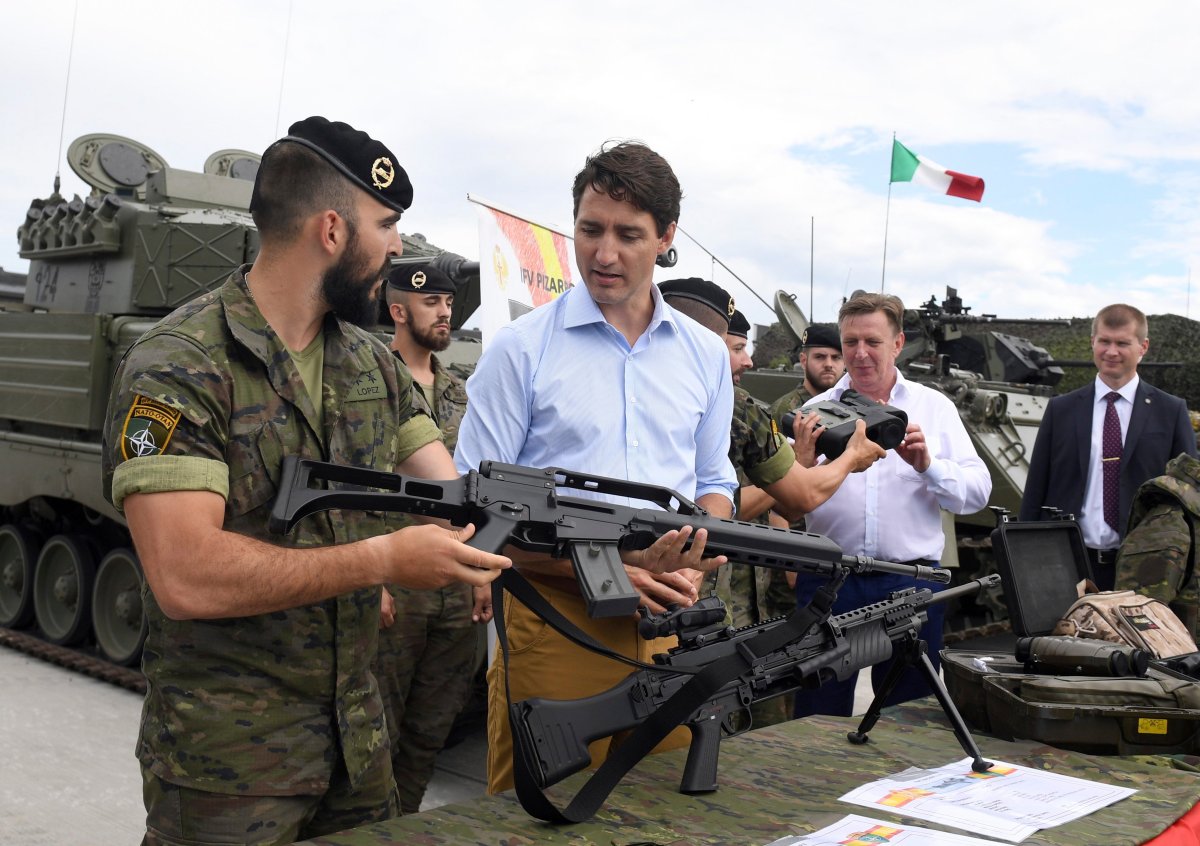 Canadian Prime Minister Justin Trudeau, center, inspects the troops as he visits Adazi Military Base in Kadaga, Latvia, on Tuesday, July 10, 2018. (AP Photo/Roman Koksarov).
