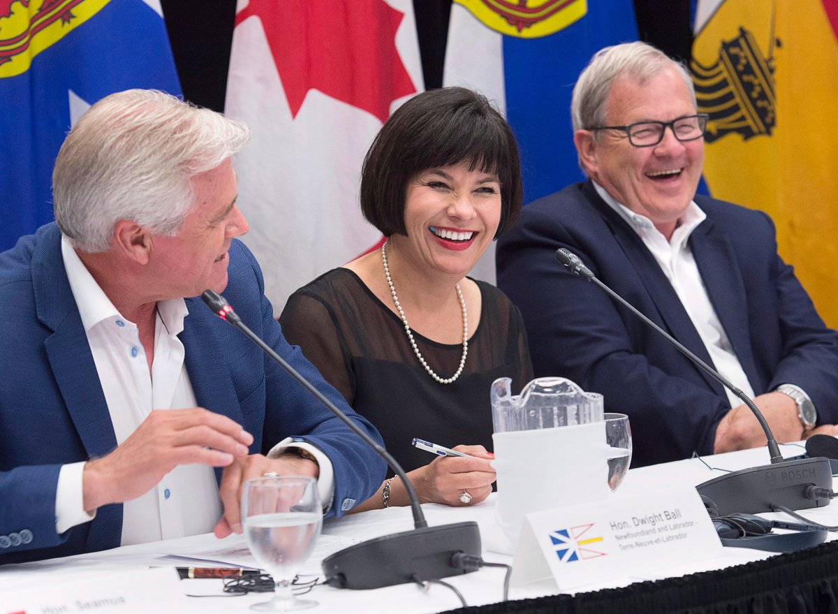 Newfoundland and Labraor Premier Dwight Ball, Health Minister Ginette Petipas Taylor and Agriculture Minister Lawrence MacAulay, left to right, share a light moment at the closing news conference of the Atlantic Growth Strategy Leadership Committee in Summerside, Prince Edward Island on Tuesday, July 10, 2018. 