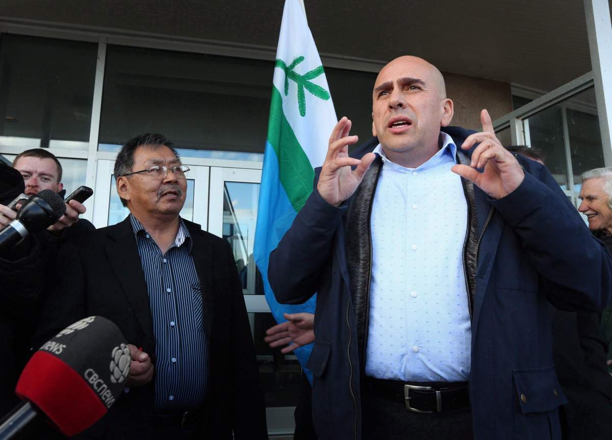 Johannes Lampe, left, President of Nunasiavut, looks on.