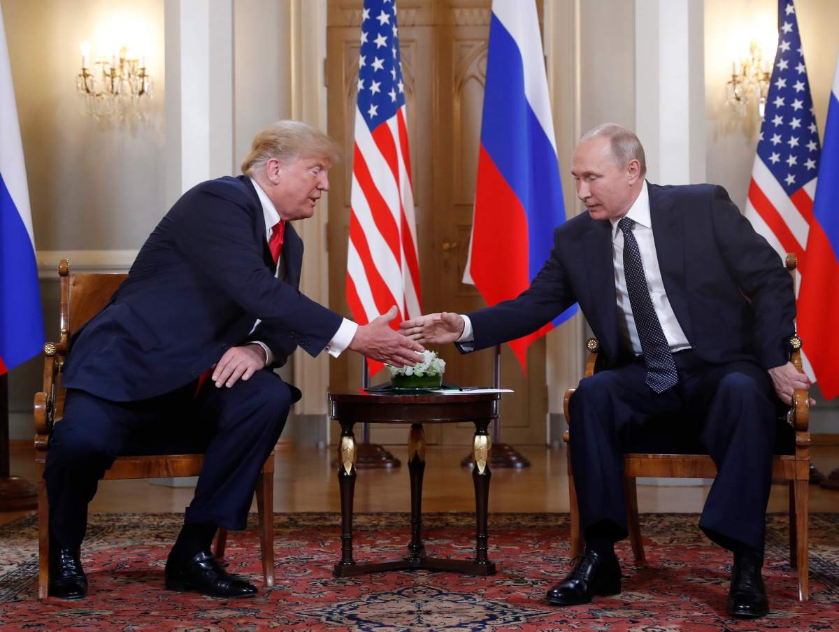 U.S. President Donald Trump, left, and Russian President Vladimir Putin shake hands at the beginning of a meeting at the Presidential Palace in Helsinki, Finland, Monday, July 16, 2018.