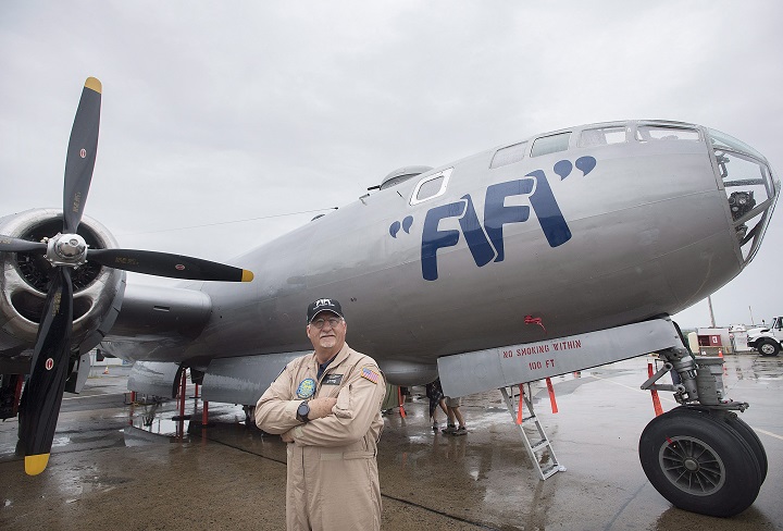 Pilot Allen Benzing poses next to FIFI, a Boeing B-29 Superfortress at Saint-Hubert airport south of Montreal, Sunday, July 22, 2018.THE CANADIAN PRESS/Graham Hughes