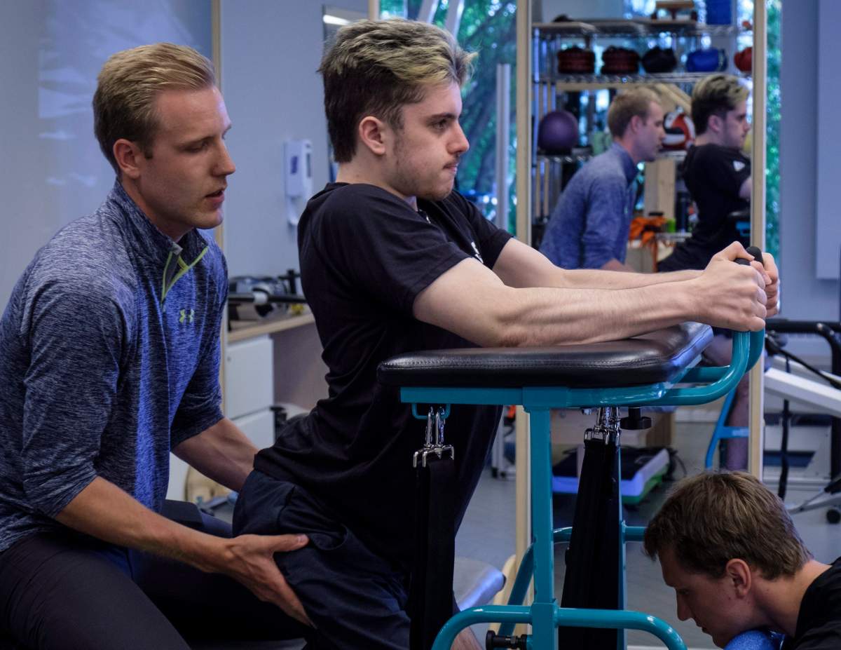 Humboldt Broncos bus crash survivor Ryan Straschnitzki, attends physio session with Kinesiologist Kirill Dubrovskiy, right, and physiotherapist Nelson Morela, left, in Calgary, Alta., Monday, July 16, 2018.