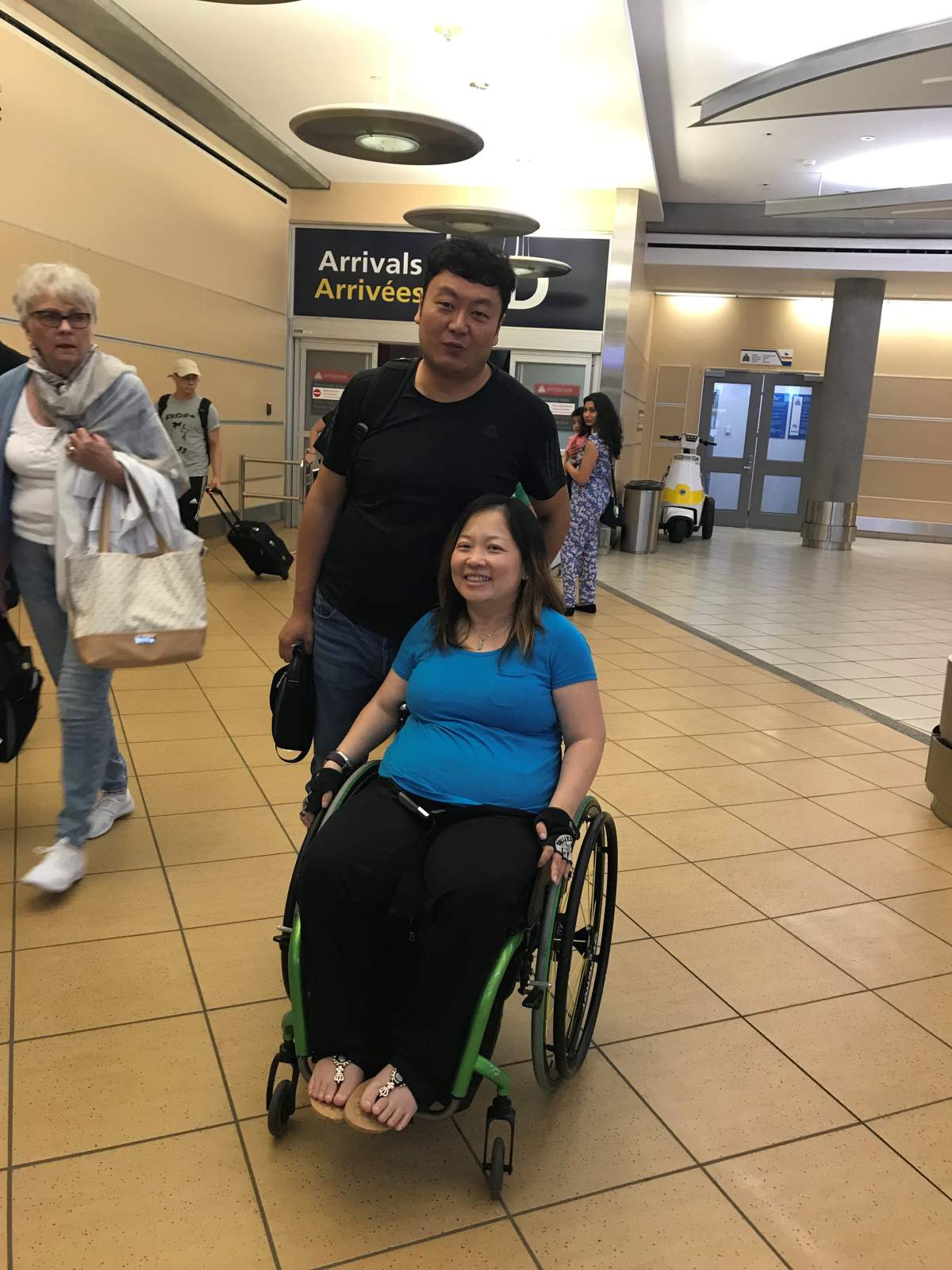 Kuen Tang and fiance Jack reunite at the Edmonton International Airport.