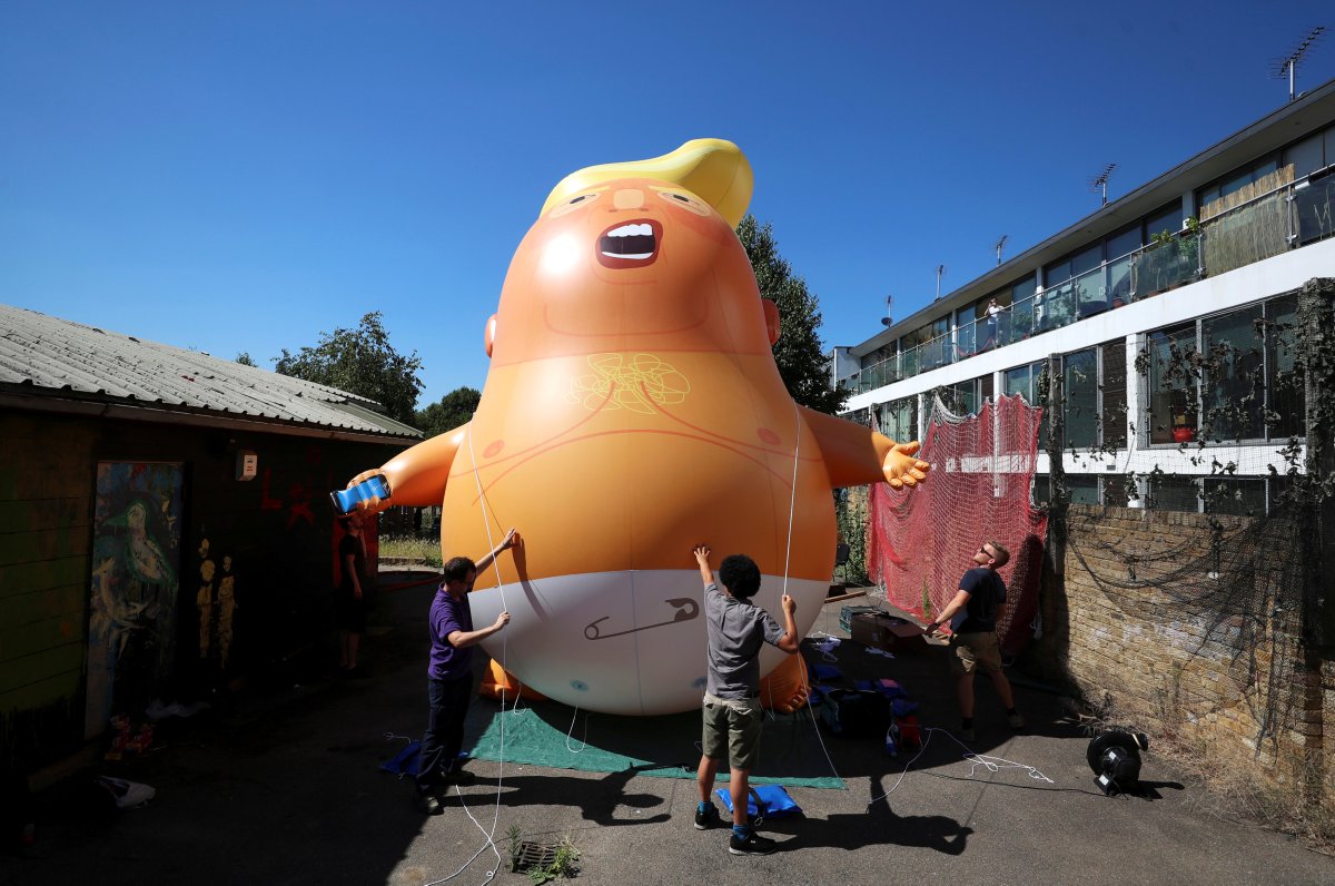 People inflate a helium-filled Donald Trump blimp which they hope to deploy during the president's upcoming visit, in London, Britain, June 26, 2018.
