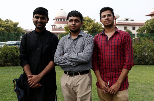 Anwesh Pokkuluri, Romel Barel and Krishna Reddy M, petitioners challenging Section 377 of the Indian Penal Code that criminalizes homosexuality, pose outside the Supreme Court in New Delhi, India, July 10, 2018.