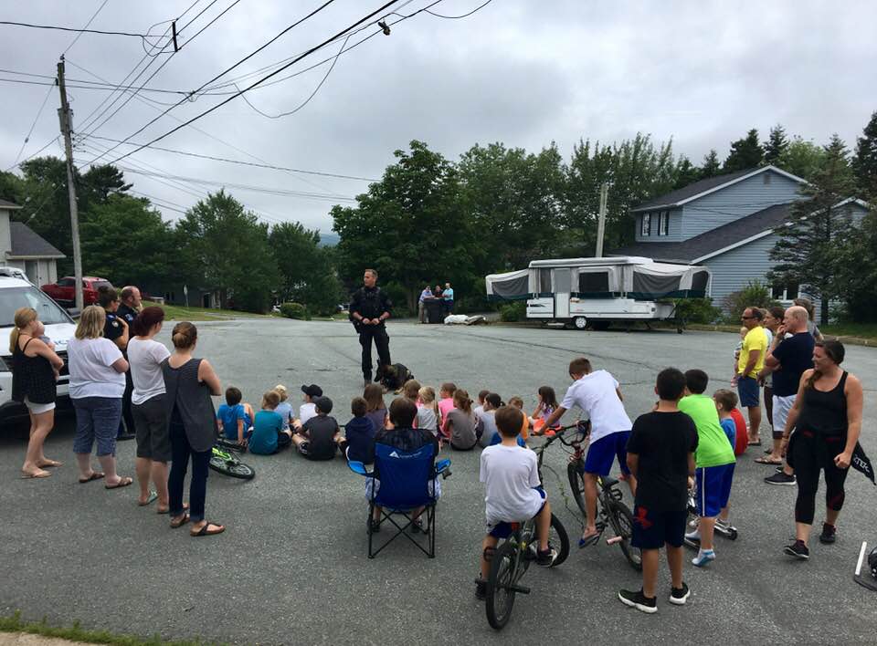 Halifax Regional Police members met with families in a Bedford neighbourhood to answer questions about their search for an armed robbery suspect the previous day.