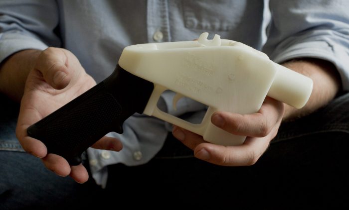 This photo taken May 10, 2013, shows Cody Wilson holding what he calls a Liberator pistol that was completely made on a 3D-printer at his home in Austin, Texas. 