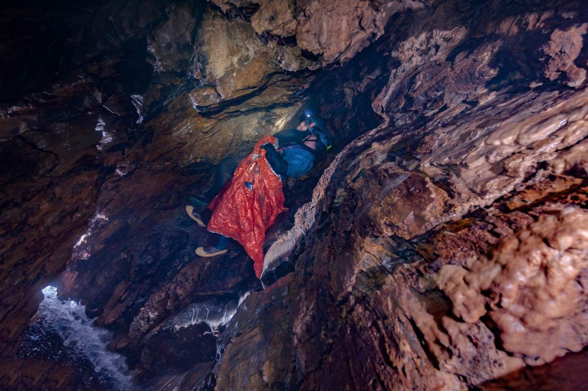 Jason showing friend Richie Johnson the ledge they took shelter on, the river now reduced to a trickle in the spring.