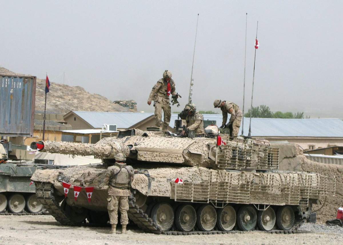 A crew from the Lord Strathcona’s Horses deck out their Leopard tank with Canadian flags to mark Canada Day on Wednesday, July 1, 2009, at Canadian forward operating base Ma’sum Ghar, Afghanistan.