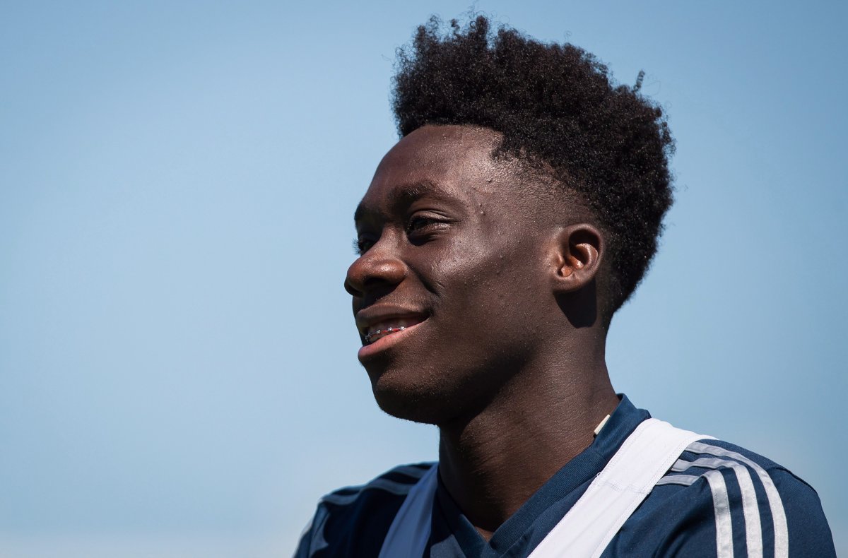 Vancouver Whitecaps midfielder Alphonso Davies smiles as he leaves the field following practice in Vancouver on Monday, July 23, 2018. 