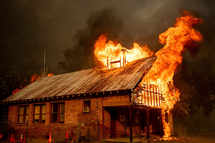 An historic schoolhouse burns as the Carr Fire tears through Shasta, Calif., Thursday, July 26, 2018.