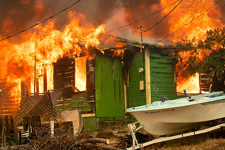 A residence burns as the Carr Fire tears through Shasta, Calif., on Thursday, July 26, 2018.