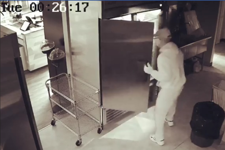 A man is seen rummaging through the fridge at Fromagerie Bothwell Tuesday.