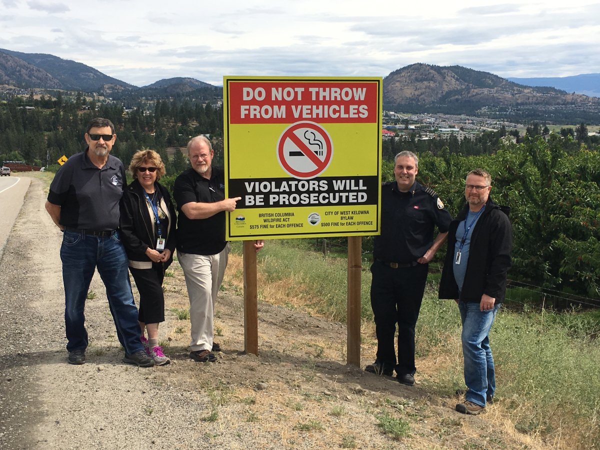 West Kelowna city council unveiled new road signs aimed at stopping motorists from flicking lit cigarettes. From left: Councillor Bryden Winsby, Councillor Carol Zanon, Mayor Doug Findlater, West Kelowna Fire Rescue Chief Jason Brolund and Councillor Rick de Jong.
