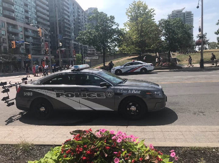 Toronto police cruisers are parked near the CN Tower on July 12, 2018.