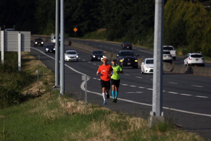 Dave Proctor runs with a friend along Hwy. 17 towards his goal of running across Canada in support of rare disease and medical study as he makes his way along Blanshard St. from Mile Zero in Victoria, B.C., on Wednesday June 27, 2018. Proctor's goal is to run 7200 kilometres in 66 days with a goal of raising 1 million dollars for research. 