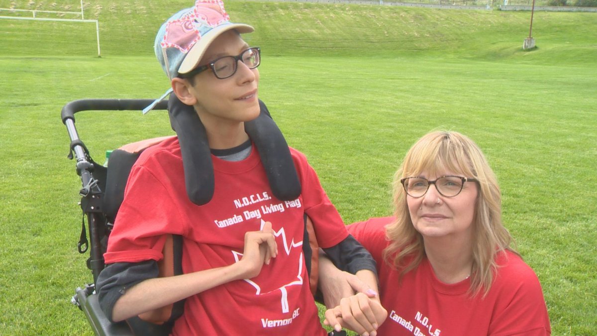 Dawson Buburuz and his mother Luanna. A Canada 'living flag' event in Vernon raised money for the Buburuz family to install an accessible washroom in their home. 