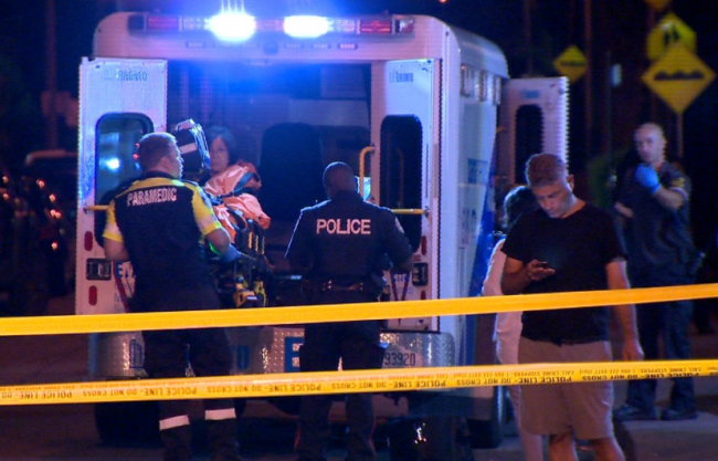 Paramedics load a victim onto an ambulance after a reported shooting in the Danforth and Logan avenues area of Toronto, July 22, 2018.