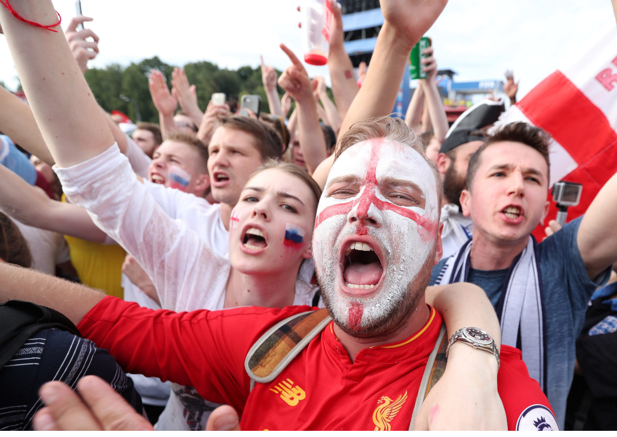 England fans celebrate their team scoring as he watches the FIFA World Cup 2018 quarter final match between England and Sweden at the Fan Fest in Moscow.