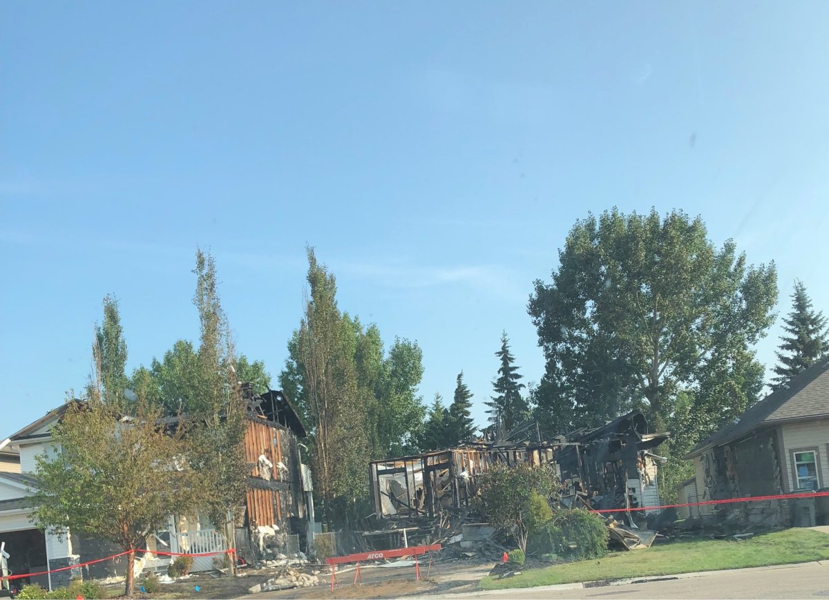A fire has destroyed two homes in Spruce Grove .