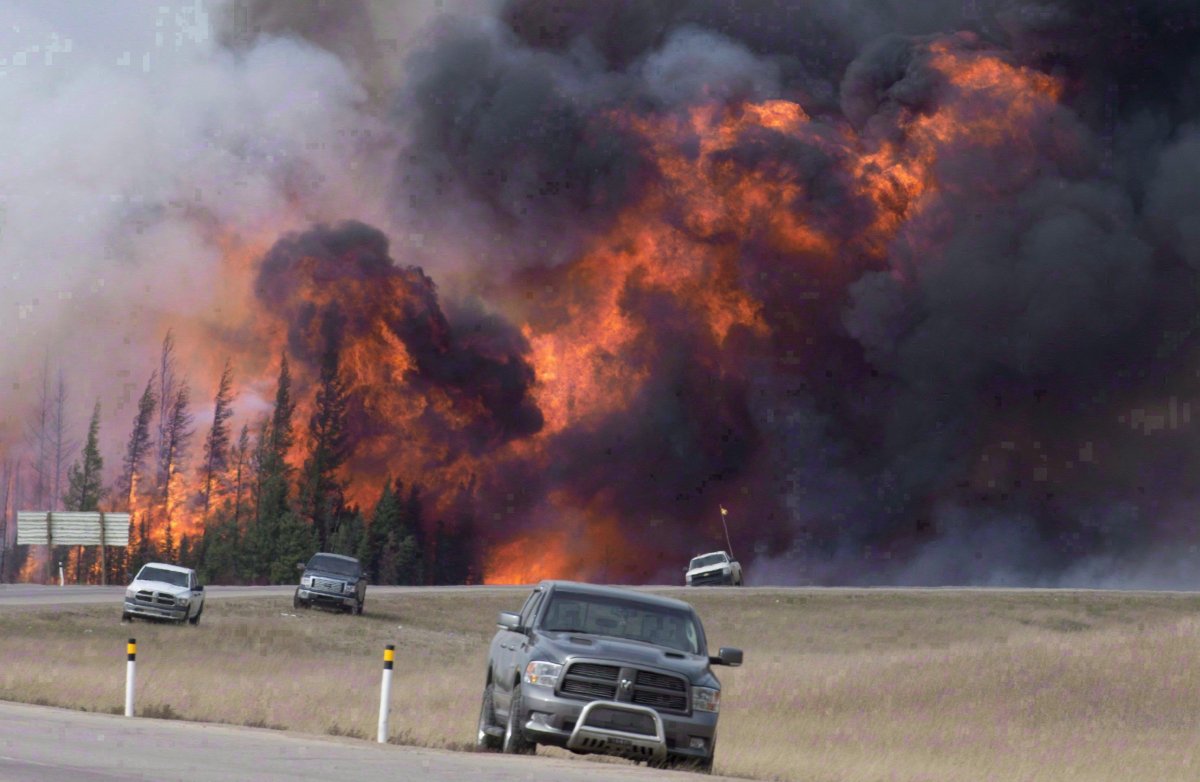 A wildfire burns through a forest south of Fort McMurray, Alta., on Highway 63 on May 7, 2016. 