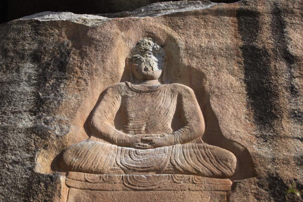 An ancient Buddha carved into into a mountainside sits defaced Oct. 10, 2007 after Islamic extremists attacked the historic relic at Jehanabad in the Swat Valley of Pakistan.