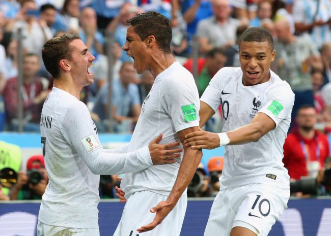 France defender Raphael Varane (centre) celebrates with teammates Antoine Griezmann and Kylian Mbappe after scoring against Uruguay in their World Cup quarter-final clash at Nizhny Novgorod Stadium in Nizhny Novgorod, Russia, July 6, 2018.