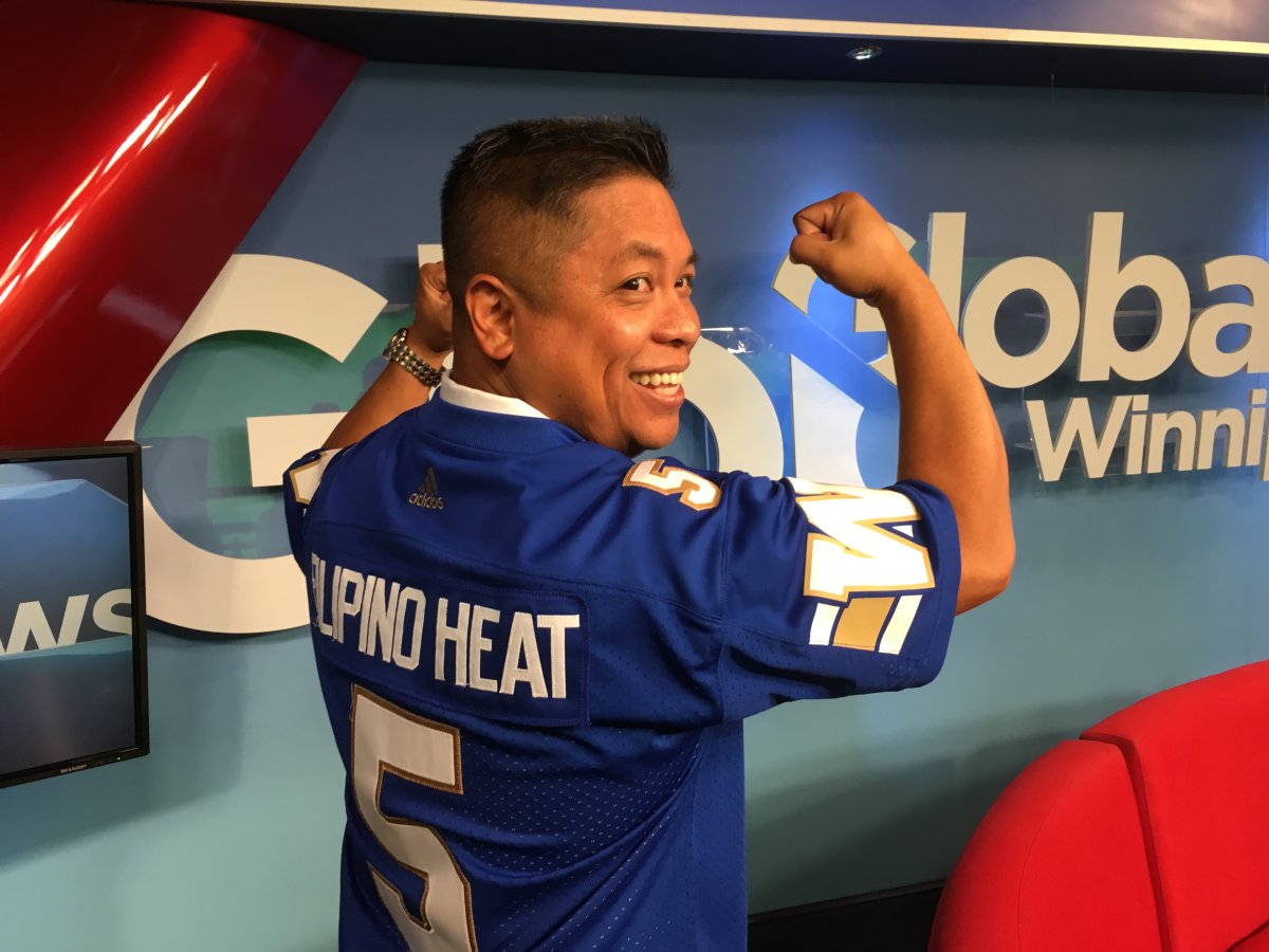 Ron Cantiveros shows off his Filipino Heat Blue Bomber jersey.
