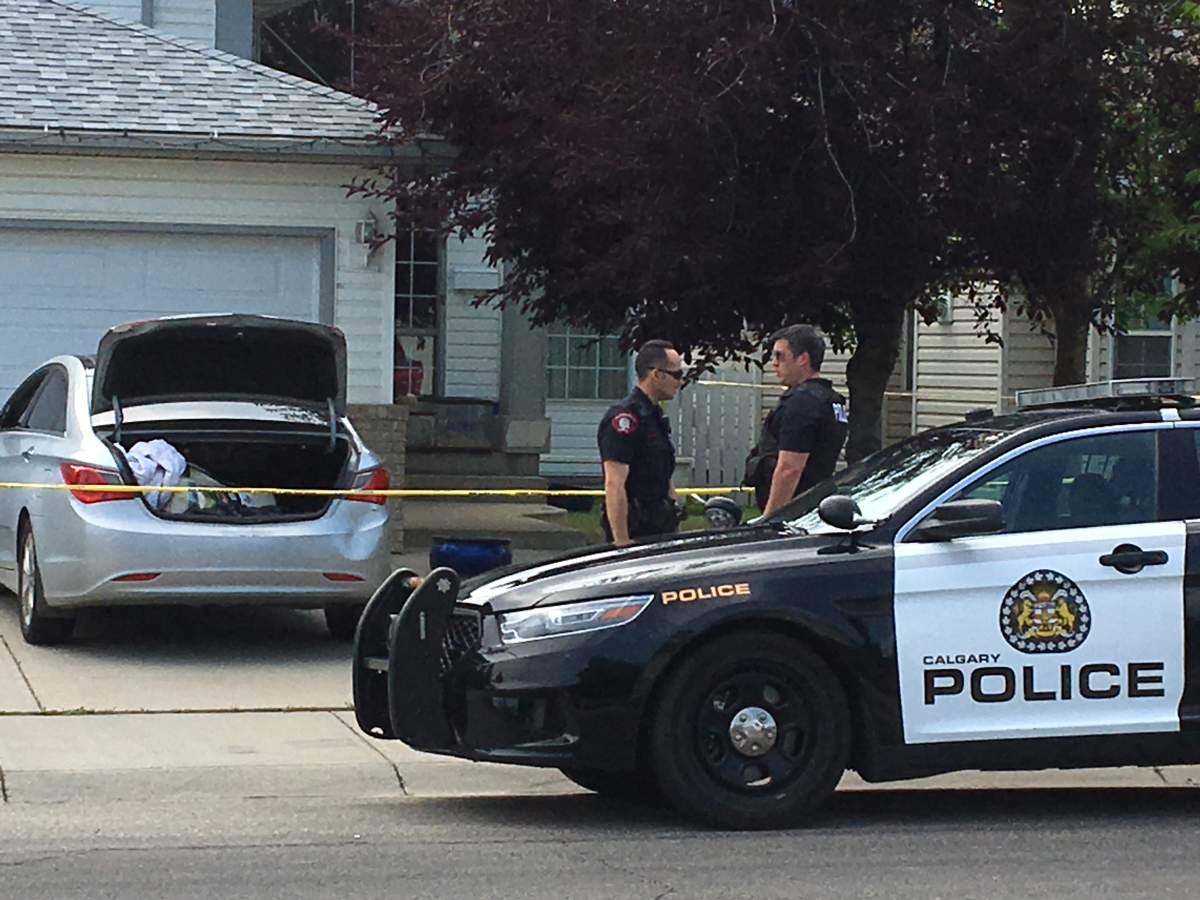 Calgary police at the scene of a home in Hidden Valley where two people were found dead on Tuesday, July 31.