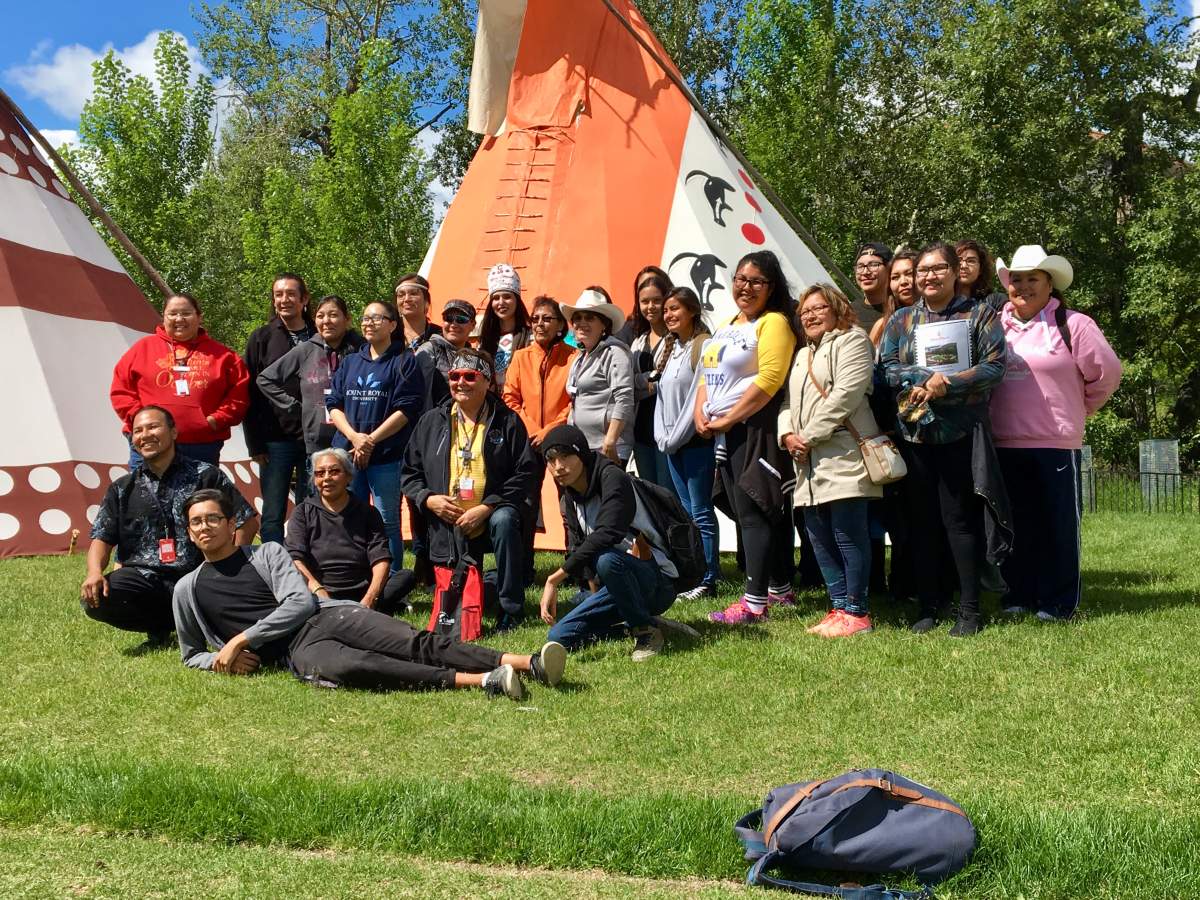 The Calgary Stampede Indian Princess poses with a group at the Stampede Indian Village.