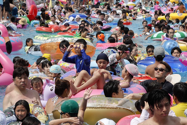Visitors jostle each other at a pool in Toshimaen amusement park in Tokyo, Japan, on July 16, 2018. The country has been recording record-high heat.