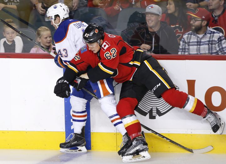 NHL profile photo on Calgary Flames' Austin Carroll, right, hitting Edmonton Oilers' Josh Currie at an NHL game in Calgary, Alberta on Sept. 26, 2016.
