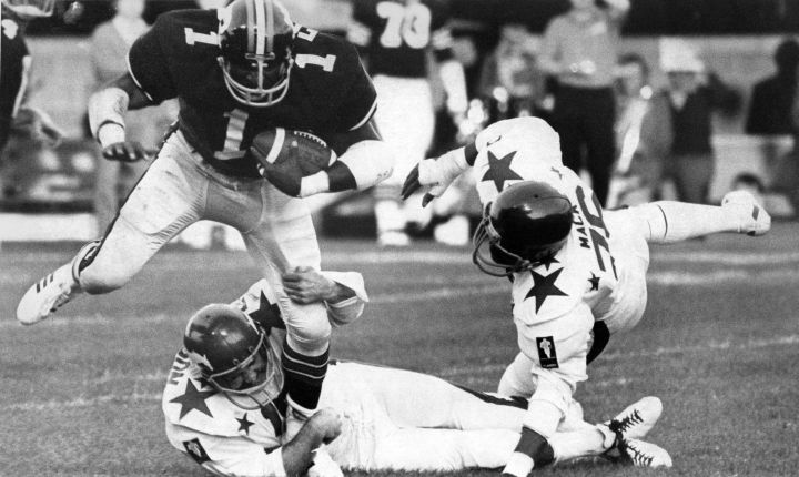 Gene Foster of the Ottawa Rough Riders (top left) is tackled by All-Star Larry Robinson of the Calgary Stampeders while Gene Mack of the Toronto Argonauts tries to help during the 1974 CFL All-Star game in Ottawa on June 26, 1974.  