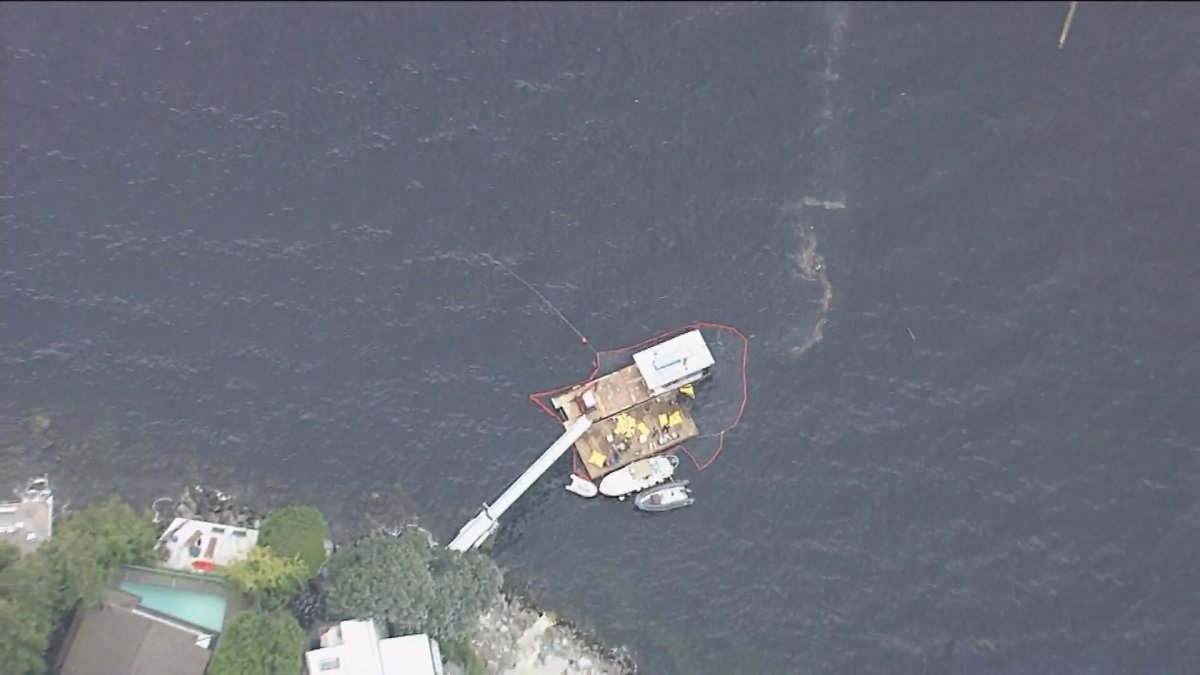 Aerial footage shows a containment boom around a barge in Howe Sound on Thursday, July 19. 