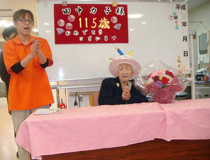 In this Jan. 2, 2018, photo provided by Goodtime Home 1, Kane Tanaka, right, is celebrated her 115th birthday at her nursing home in Fukuoka, southwestern Japan. 