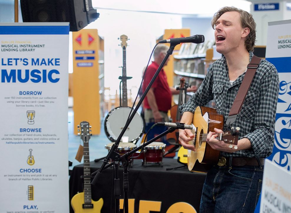 Joel Plaskett plays a tenor guitar as he participates the launch of a musical instruments lending program at the Halifax Public Library in Dartmouth, N.S., on Wednesday, July 11, 2018. 