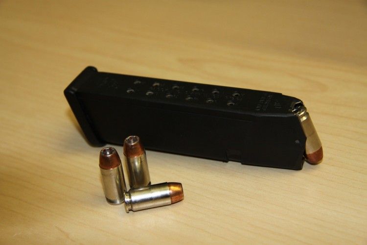 Police in Calgary are searching for a handgun magazine that was pulled off an officer's belt during a skirmish with a suspected car prowler.
