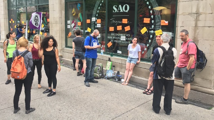 SAQ employees picket in front of downtown Montreal outlet on Tuesday, July 17, 2018.