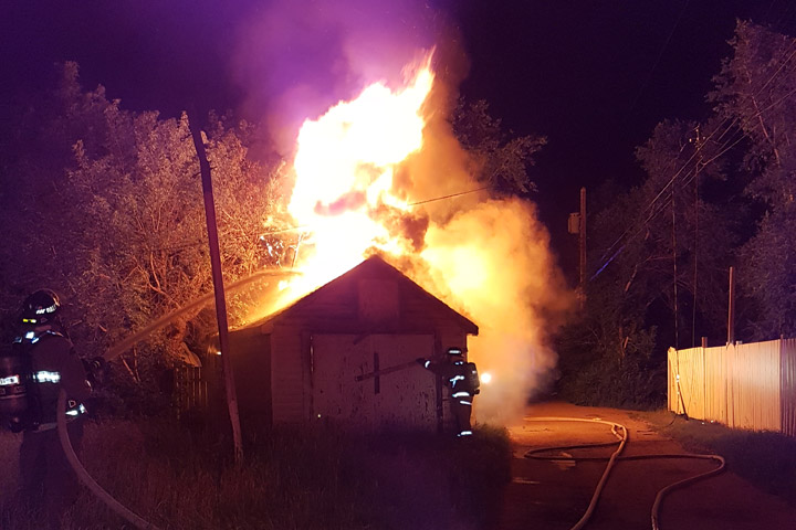 Saskatoon firefighters arrived at a garage fire to find flames shooting in the air and a downed power line sparking from the intense heat.