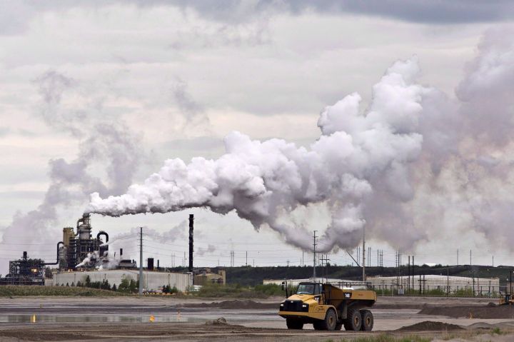 A dump truck works near the Syncrude oil sands extraction facility near the city of Fort McMurray, Alberta on Sunday June 1, 2014.