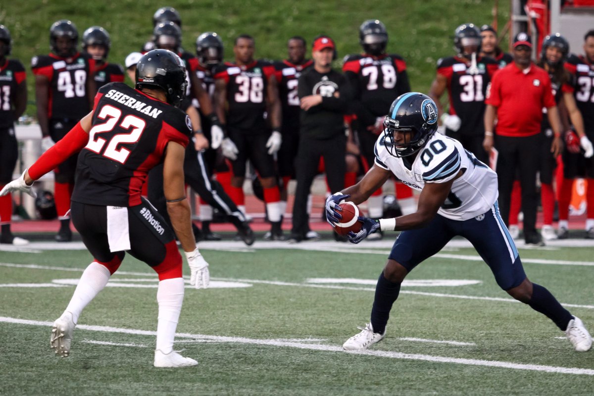 Toronto Agronauts slot back Bralon Addison (00) snags the ball and tries to elude Ottawa Redbacks defensive back Teague Sherman (22) during the first half of the CFL preseason football action in Guelph, Ont. on Thursday June 7, 2018.