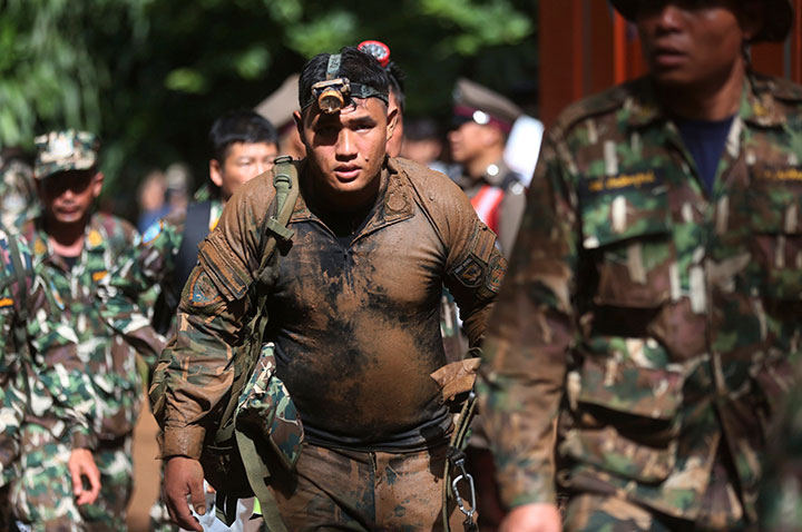 Thai soldiers searching for the missing children and their coach march out of the Tham Luang Nang Non cave in Mae Sai, Chiang Rai province, in northern Thailand on Friday, June 29, 2018.