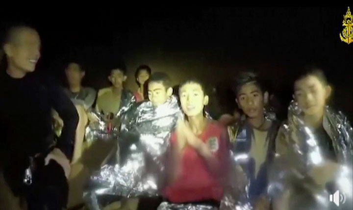In this July 3, 2018 image taken from video provided by the Thai Navy Seals, Thai boys are with Navy Seals inside the Mae Sai cave, northern Thailand.