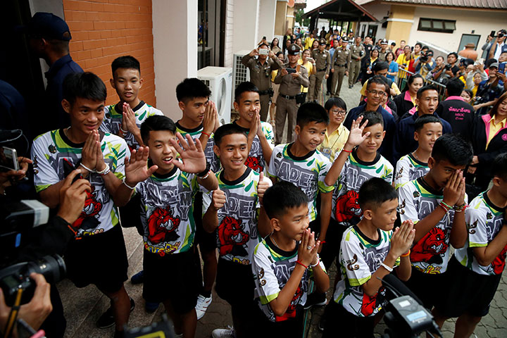 The 12 boys and their soccer coach who were rescued from a flooded cave arrive for a news conference in the northern province of Chiang Rai, Thailand, July 18, 2018. Three of the boys rescued from the cave and their coach have been granted Thai citizenship.