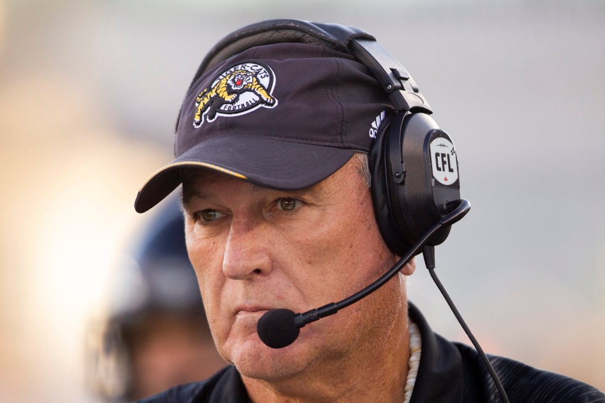 Hamilton Tiger-Cats head coach June Jones looks on at the start of the the CFL game against the Saskatchewan Roughriders in Hamilton, Ontario on Thursday, July 19, 2018. 