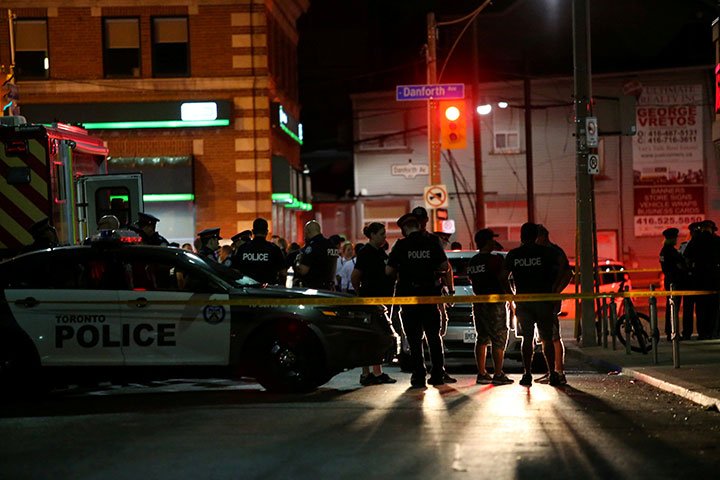 Police are seen near the scene of a mass shooting in Toronto, July 22, 2018.