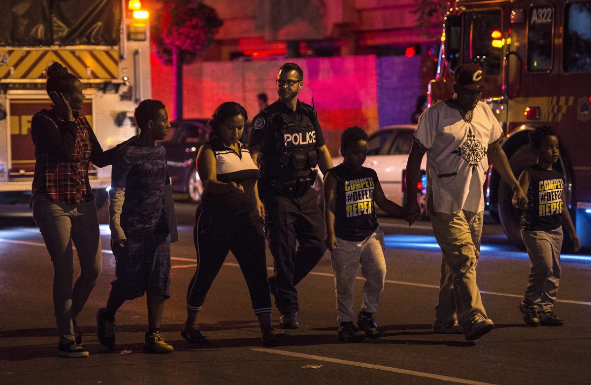Police escort civilians away from the scene of a mass casualty incident in Toronto on Sunday, July 22, 2018.