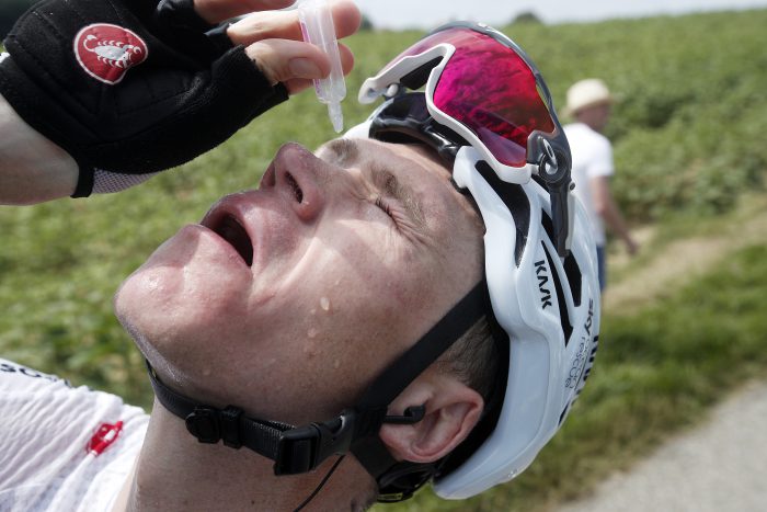Team Sky rider Chris Froome of Britain cleans his eyes after tear gas was used by policemen against protesting farmers between Carcassonne and Bagneres-de-Luchon, France, 24 July 2018.