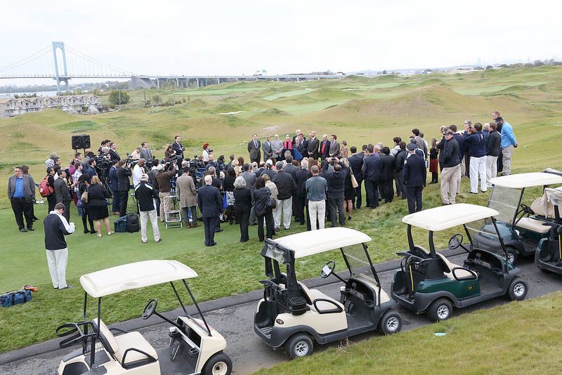 A crowd gathers at the announcement of the completion of a golf course at Ferry Point Park in New York City. Trump Golf Links is the course's name.